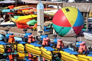 Colorful watercraft rentals waiting to be used on the water