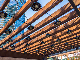 Festive lights strung around a patio structure for outdoor celebrations in downtown Bellevue, WA,...