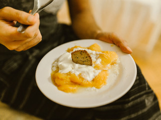 Mango fruit with yogurt and spoon in hotel