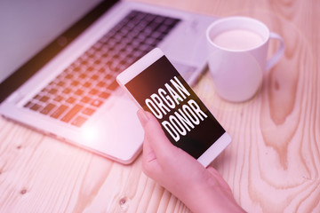 Writing note showing Organ Donor. Business concept for the act of donating an organ to a demonstrating needed a transplant woman with laptop smartphone and office supplies technology