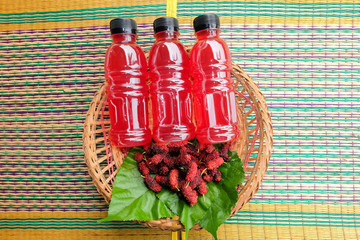 Refreshing mulberry juice in the bottles with berries on table, Healthy fruit, Organic...