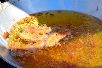 Fried banana in a pan with hot oil, Fried Banana, Banana Deep Fried, Thai snack on sell in the market.
