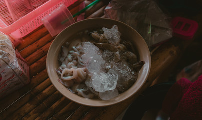 Shrimp and squid rings in bowl with Ice, Asian kitchen