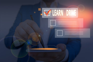 Writing note showing Learn Drive. Business concept for to gain the knowledge or skill in driving a...