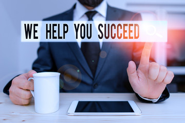 Text sign showing We Help You Succeed. Business photo showcasing Aided Supported Funded someone to reach his dreams Male human wear formal clothes present presentation use hi tech smartphone