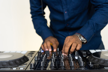 Dj mixes the track in the nightclub at party