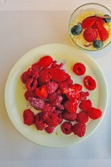 Bowl of fresh red raspberries in milk
