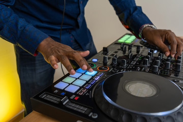 Dj mixes the track in the nightclub at party