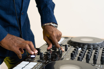 Dj mixes the track in the nightclub at party