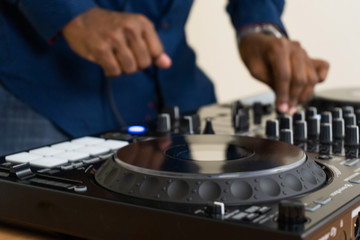 Dj mixes the track in the nightclub at party