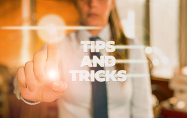 Word writing text Tips And Tricks. Business photo showcasing helpful advices that makes certain action easier to do Blurred woman in the background pointing with finger in empty space