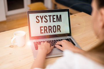 Writing note showing System Error. Business concept for instruction that is not recognized by an...