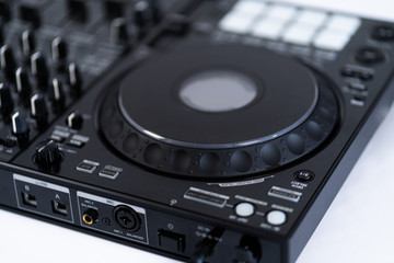 Fototapeta premium Professional concert dj turntables player device with sound mixer panel and jog wheel.Club disc jockey stage equipment for playing music on party.Digital turn table deck for nightclub