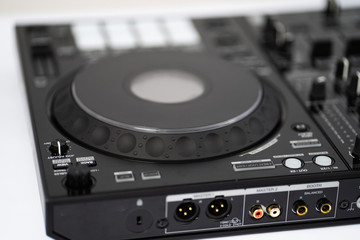 Fototapeta premium Professional concert dj turntables player device with sound mixer panel and jog wheel.Club disc jockey stage equipment for playing music on party.Digital turn table deck for nightclub