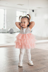 a girl is trying on clothes: sparkly dress. the concept of clothing for the whole family,...