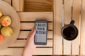 Conceptual hand writing showing Create Your Future. Concept meaning Set Target and Career goals Plan ahead Reach out woman with laptop smartphone and office supplies technology