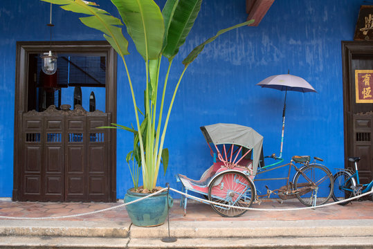 Malaysia - May 4, 2016: Old rickshaw at Cheong Fatt Tze Mansion (Blue Mansion) in Georgetown, Penang. The historical building is now used as a hotel. And parts of it can be visited on daily tours.