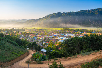 Muang Long village in the golden triangle, Luang Namtha North Laos near China Burma Thailand, small town in river valley with scenic mist and fog. Travel destination for tribal trekking Akha village