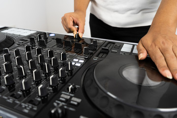 Hands of DJ mixing tracks on professional Dj Mixer