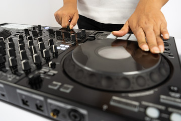 Hands of DJ mixing tracks on professional Dj Mixer