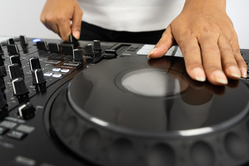 Hands of DJ mixing tracks on professional Dj Mixer