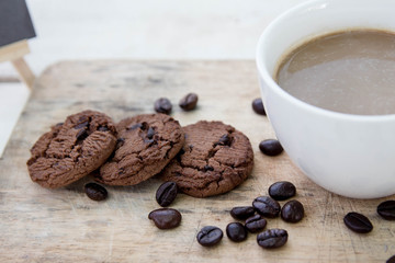 Coffee cup and coffee beans on table