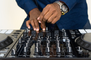 Dj mixes the track in the nightclub at party