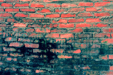 Red brick background: closeup of an old uneven brick wall.