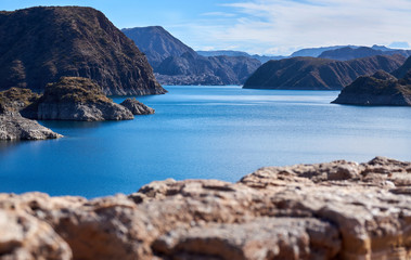 Fototapeta na wymiar Blue lake with mountains in Valle Grande Mendoza Argentina in summer