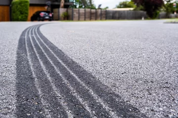 Deurstickers Tyre track on asphalt from hard braking - shallow focus © Greg Brave