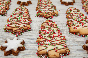 Christmas tree biscuits on white wood in perspective with shallow focus
