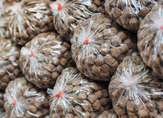 Pile feed pack in plastic bag for sale at the public park. Feed for fish and animal feed.
