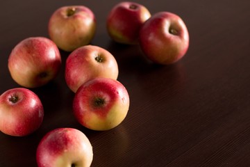red apples on a dark wooden kitchen table
