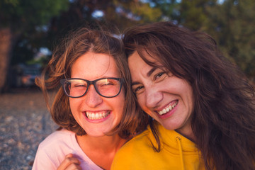 Two happy woman friends laughing