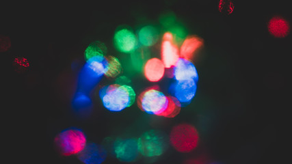 Christmas colorful New Year's Bokeh neon lights. Abstract Blurred photo background with blinking...