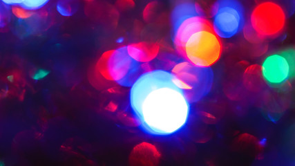 Christmas colorful New Year's Bokeh neon lights. Abstract Blurred photo background with blinking...