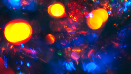Christmas colorful New Year's Bokeh neon lights. Abstract Blurred photo background with blinking...