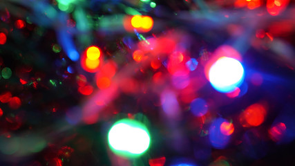 Christmas colorful New Year's Bokeh neon lights. Abstract Blurred photo background with blinking...