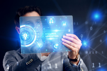 Planning marketing strategy. Business, Technology, Internet and network concept. Businessman working on the tablet of the future, select on the virtual display: Affiliate marketing