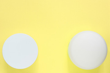 Cosmetic jars on a yellow background. Health and beauty. Top view, copy space