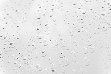 Raindrop water dew drop on glass wet white gray blue background.