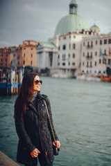 Fototapeta na wymiar female tourist walking around and exploring venice in the early spring