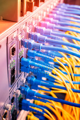 Fiber Optic cables connected to an optic ports and Network cables connected to ethernet ports