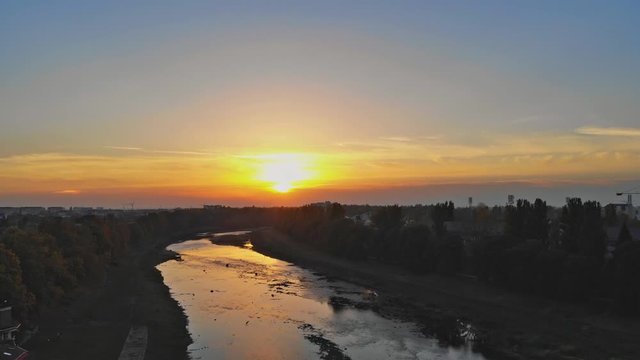 View from the height of the city on the roofs of houses, trees, mountains in over the Uzh River