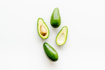 Avocado - ripe and bright, cutted in half - on white background top view copy space
