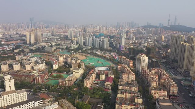 China city planning and renovation - aerial view of old disappearing neighborhoods and sprawling city of Qingdao