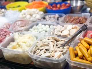 Ingredient for spicy salad: Vietnamese pork sausage, dory fish fillet, calamari, and meatballs in plastic food boxes