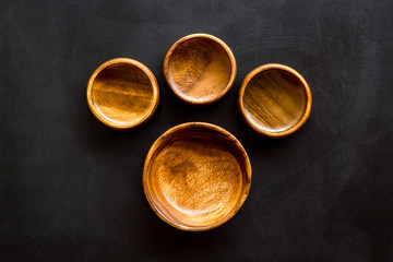 Making wooden dishes. Empty bowls on black background top view