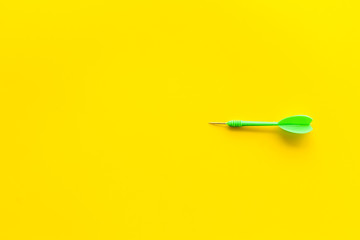 Plastic dart or arrows for darts game on yellow background top view copy space