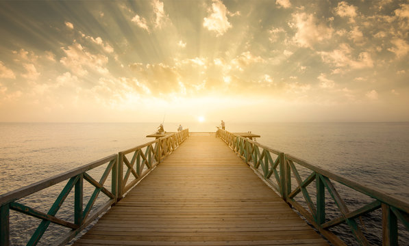 Fototapeta Wooden pier on sea at morning sunrise